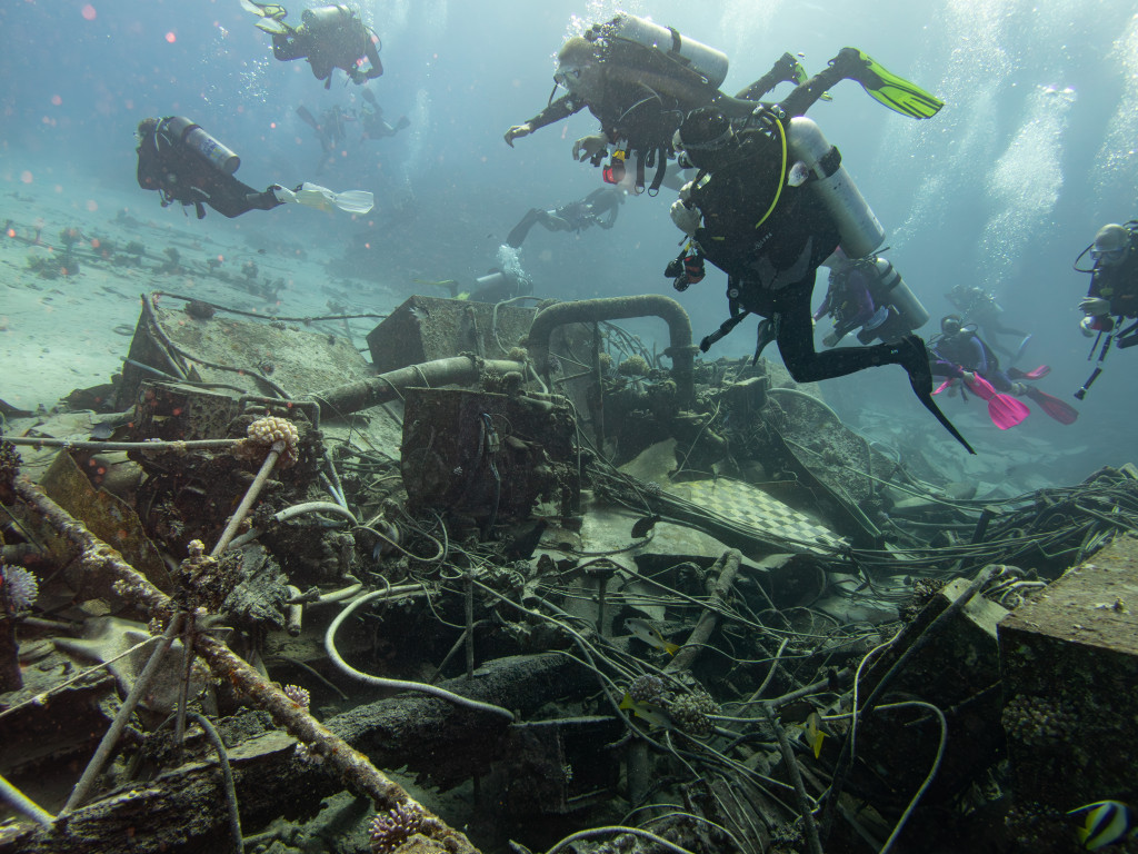 a group of divers at a wreck